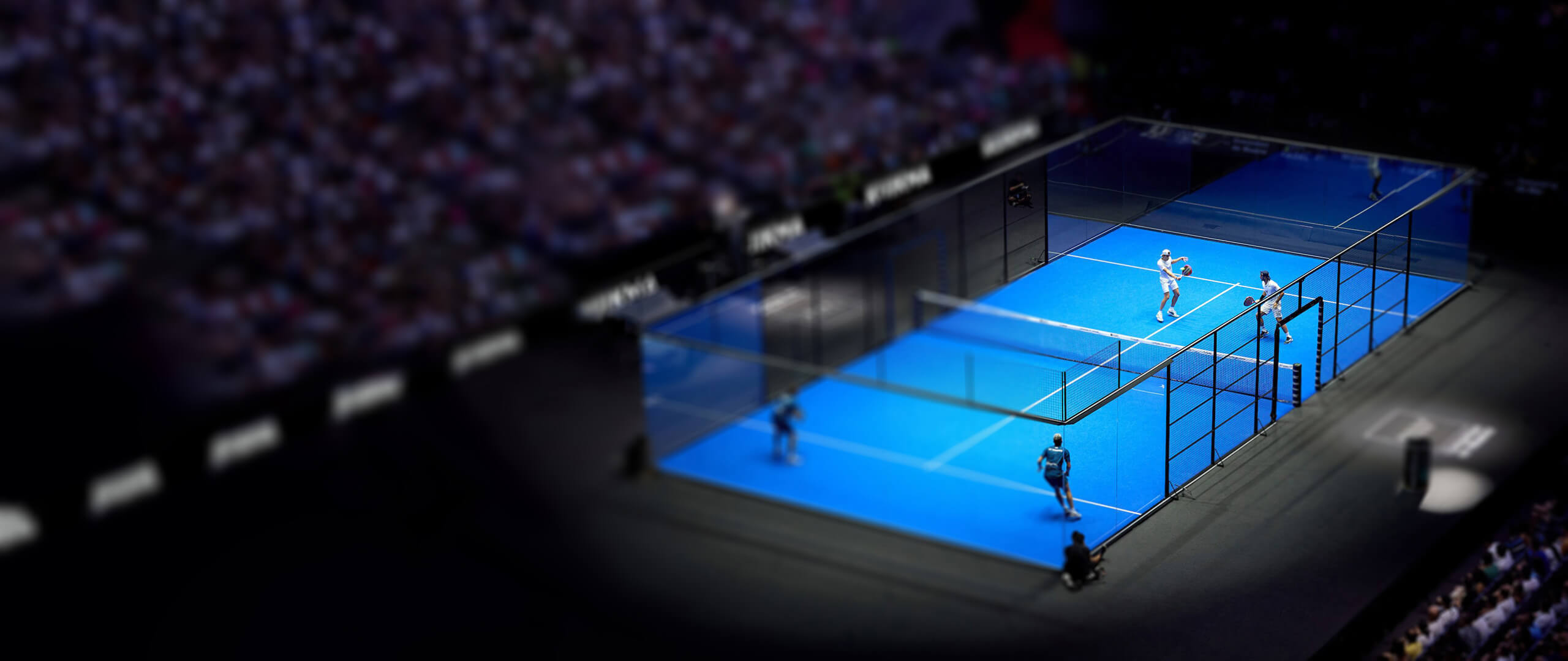 An elevated view of a padel tennis tournament match underway in a stadium setting in Montreal, showcasing a major padel event.